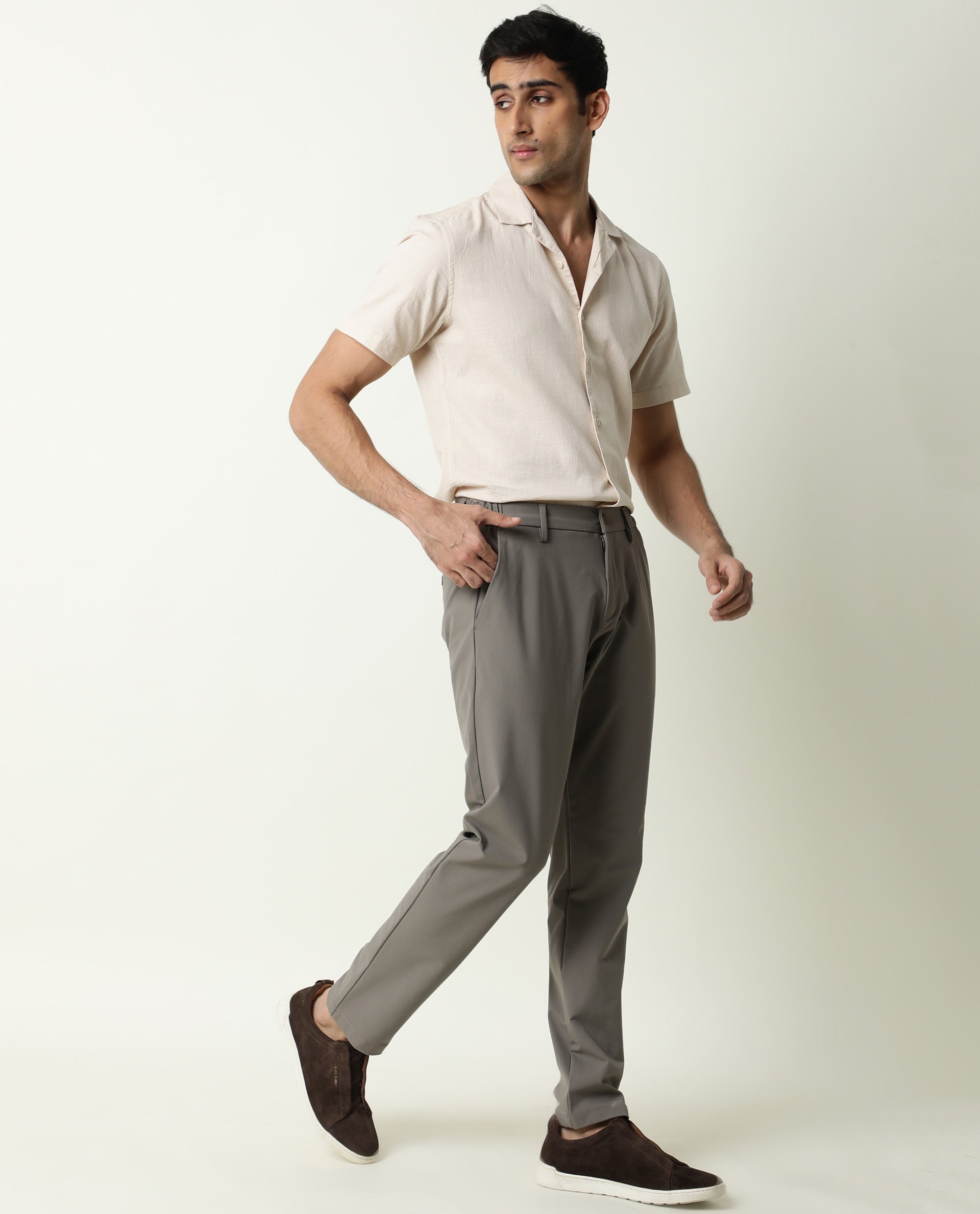 Vertical full-length portrait of serious handsome attractive virile  masculine pensive foreigner wearing formal outfit white shirt beige pants  walking in city center architecture houses background Stock Photo | Adobe  Stock